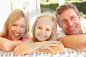 Portrait Of Young Family Relaxing Together On Sofa