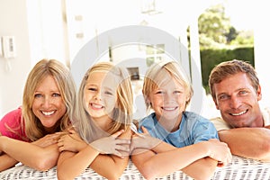 Portrait Of Young Family Relaxing Together On Sofa