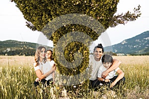 Portrait of a young family smiling and happy looking at the camera on the outside