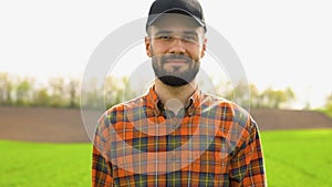 Portrait of young farmer at green agriculture field