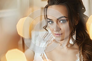 Portrait of young fashion bride model with perfect face skin, makeup and wedding hairstyle on unfocused background