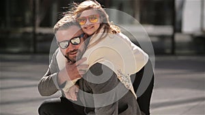 Portrait of Young Father Carrying His Daughter On His Back. Family Having a Lot of Fun Spending Father`s Day Together.