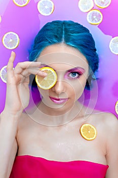 Portrait of young female in bathtub with pink water