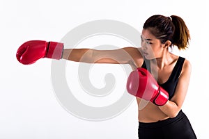 Portrait of a young female boxer punching on white isolated background with copy space