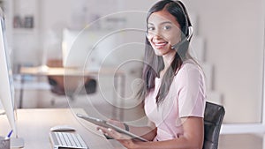 Portrait of a young female customer service agent working in ecommerce and sales. Business woman working on a tablet in