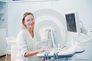 Portrait of young female dentist in office