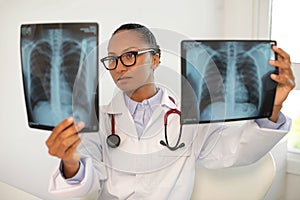 Portrait of young female doctor examining radiological images photo