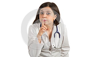 Portrait of young female doctor showing shh sign, silence.