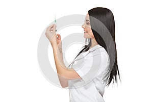 A portrait of a young female doctor smiling with a syringe in her hand