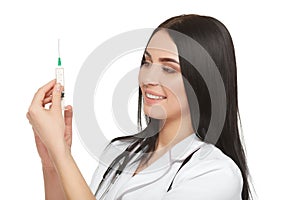 A portrait of a young female doctor smiling with a syringe in her hand