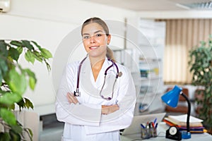 Portrait of a young female doctor standing in a resident's office