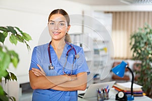 Portrait of a young female doctor standing in a resident's office