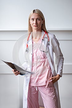 Portrait of young female doctor in white coat.