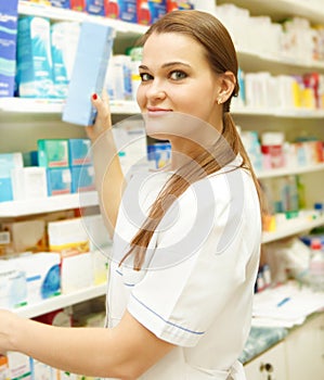 Portrait of young female pharmacist showing medici