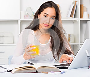 Portrait of young female sitting and writing