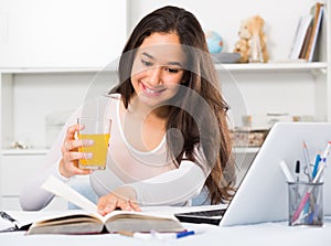 Portrait of young female sitting and writing