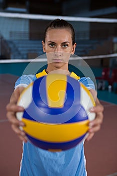 Portrait of female sportsperson holding volleyball photo