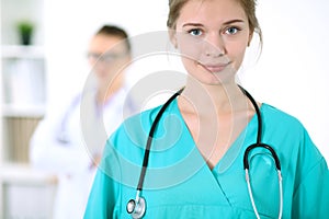 Portrait of young female surgeon doctor in a hospital