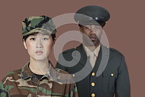 Portrait of young female US Marine Corps soldier with male officer in background