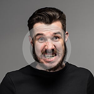 Portrait of young fierce man in studio