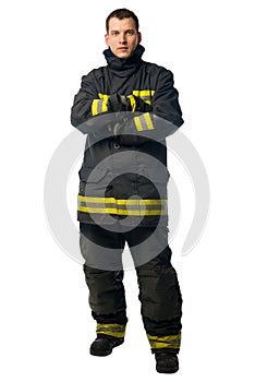 Portrait of a young firefighter in dirty work clothes isolated