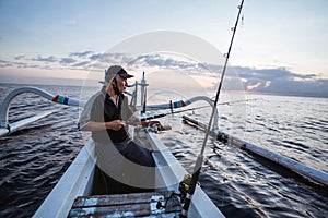 Portrait of a young fisherman fishing on a boat