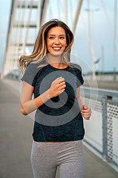 Portrait of young fit attractive happy fitness woman in city. People healthy lifestyle concept.