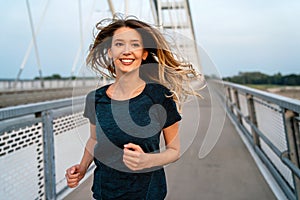 Portrait of young fit attractive happy fitness woman in city. People healthy lifestyle concept.