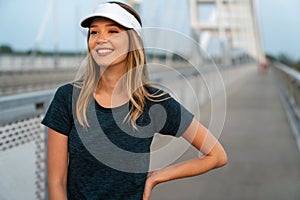 Portrait of young fit attractive happy fitness woman in city. People healthy lifestyle concept.