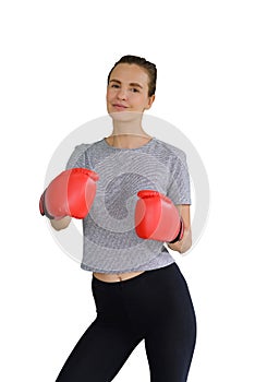Portrait of young fitness sporty woman in sportswear with red boxing gloves punching hit isolates on white background. healthy