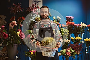 Portrait of young florist with cactus