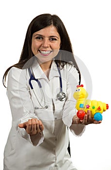 Portrait of young friendly female doctor holding toys