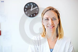 Portrait of a young friendly female nurse or a doctor.