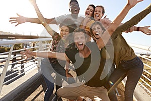 Portrait Of Young Friends Outdoors Posing On Gangway Together