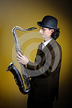 Portrait of young gentleman playing saxophone photo