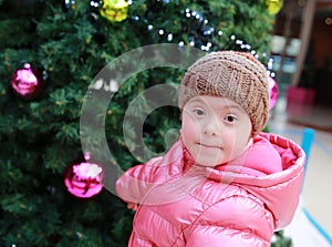 Portrait of young girl on background of the christmas tree