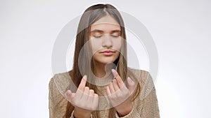 Portrait of young girl beckoning, attracting or calling you with fingers