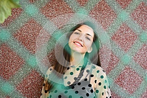 Portrait of a young girl behind a green net