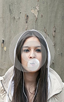 Portrait of young girl blowing bubble gum