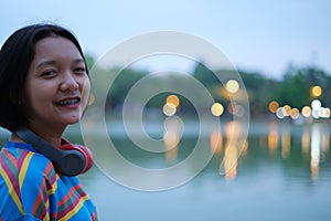 Portrait young girl with Bokeh at river,Roi-et Thailand