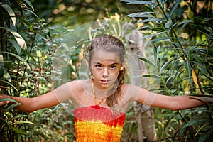 Portrait of a young girl in the bushes