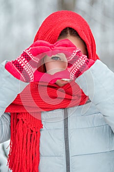 Woman hands in red winter gloves. Heart symbol shaped Lifestyle and Feelings concept.