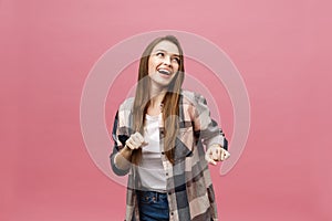 Portrait young girl dancing with inspired face expression. Active young woman in casual summer outfit having fun indoor.