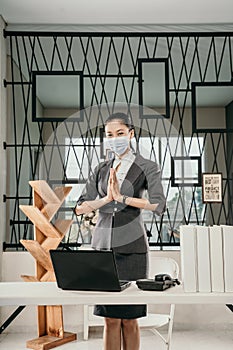 Portrait of young girl employe with laptop in office