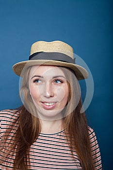 Portrait of  young   girl   in  hat  blue background