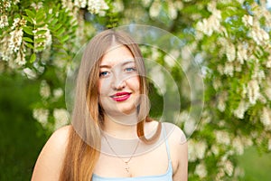 Portrait of young girl long hair plus size spring surrounde