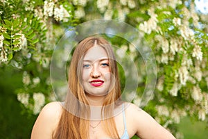 Portrait of young girl long hair plus size spring surrounde