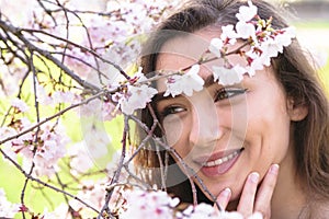 Portrait of young girl looking at blossom branch