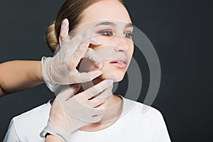 Portrait of a young girl with a mask removed from her face.