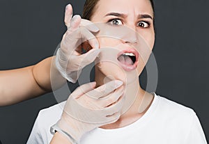 Portrait of a young girl with a mask removed from her face.